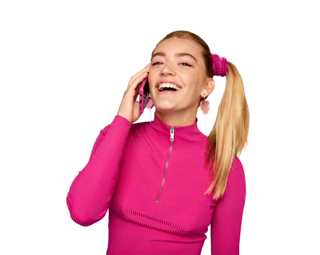 A smiling girl with a phone to her ear